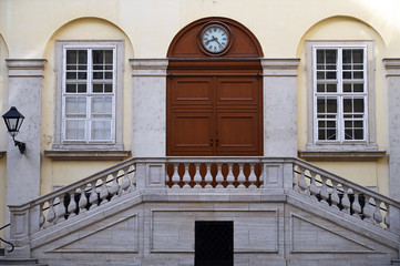 Old building with stairway and clock in Vienna Austria