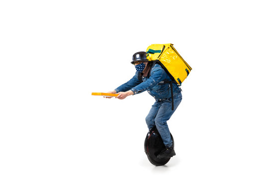 Too Much Orders. Contacless Delivery Service During Quarantine. Man Delivers Food Wearing Gloves And Face Mask Isolated On White. Taking Pizza On Unicycle Isolated On White Background. Safety.