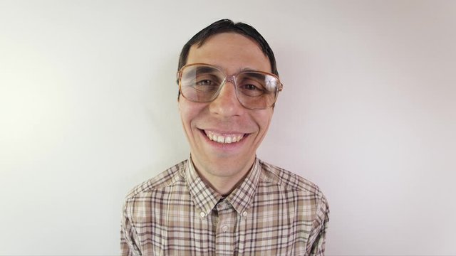 Portrait of funny nerd in glasses