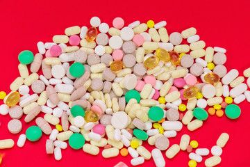 Fototapeta na wymiar Medical pills on red background. Top view. Medicine concept