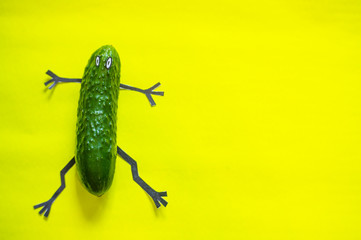 Сucumber man with handles and legs on a bright and yellow background