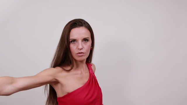 Young Attractive Woman Brunette In Purple Stylish Dress, With Crown On Head White Background, Aggressive Female Made Defensive Stance Hands And Is Ready To Strike. Human Self-Defense, Karate, Kung Fu
