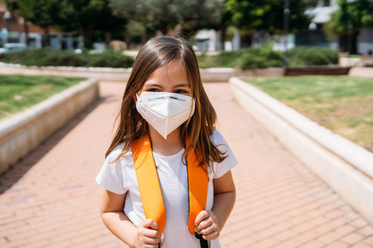 Little Girl With Mask In A Park During The Coronavirus Pandemic