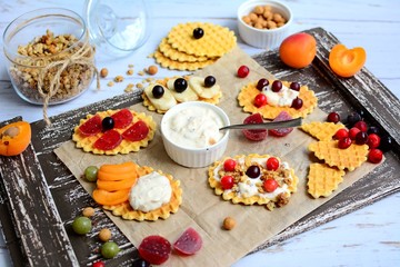 Belgian waffles with fresh berries, yogurt and granola on a rustic wooden background. Healthy breakfast