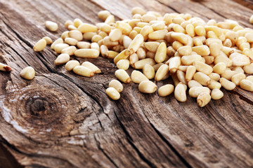 Some fresh Pine Nuts on vintage background. unshelled healthy vegetarian food background