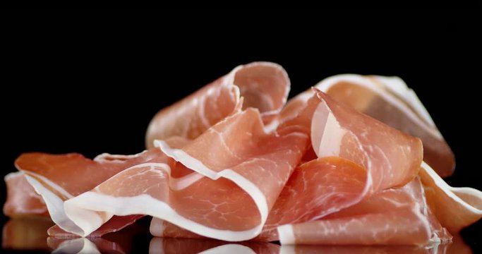 Antipasto of slices of bacon slowly rotates.