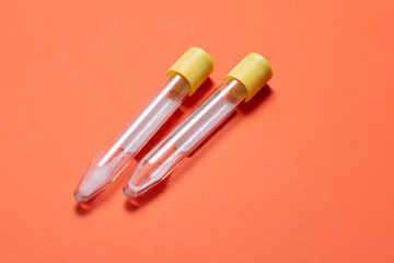 Empty medicine blood tubes for test on orange background