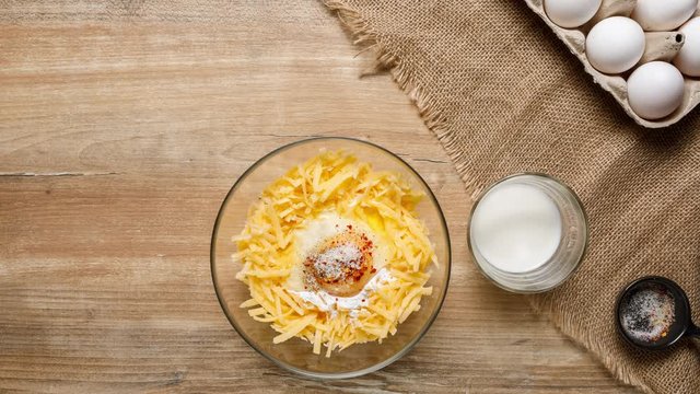 Top view of cooking a lazy khachapuri pie on a rustic table. 4K stop-motion animation.