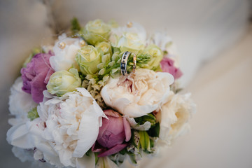 Wedding rings close-up on a beautiful wedding bouquet. Wedding accessories