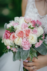 Beautiful and sophisticated wedding bouquet close-up holds the bride in her hands. Wedding bouquet