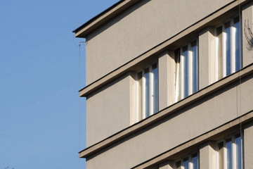 glass balconies of a multi-storey building made of concrete. housing for people in a big city. French glazing of an apartment complex.