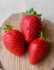 Strawberry close up on wooden background. Sweet, ripe strawberries. Healthy food. A lot of vitamin C of fruits. 
