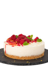 Cheesecake with raspberriees, plum and mint leaves isolated on white background