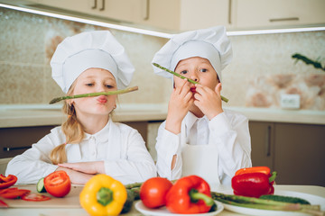 little cooks cut vegetables for salad