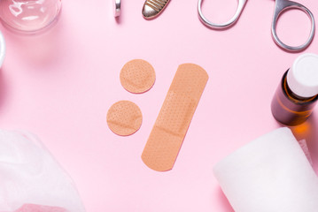 Set of adhesive bandage, medical sticking plaster on pink background