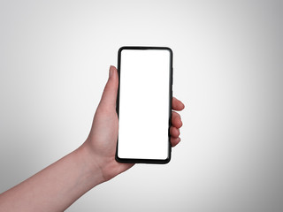 A single woman's hand holding a black isolated smartphone with a blank screen. Concept for design, website and app mockups.