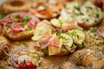 Composition of various homemade bagels sandwiches with sesame and poppy seeds