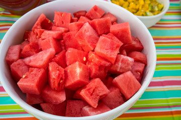 Fresh cut-up watermelon served in a bowl at a picnic