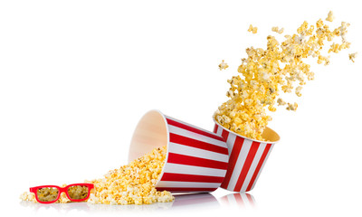 Set of flying popcorn from paper bucket and scattered popcorn isolated on white