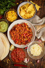 Mexican food concept. Vegetable burritos. Served on pan. Tortilla guacamole, salsa, chilli and beans