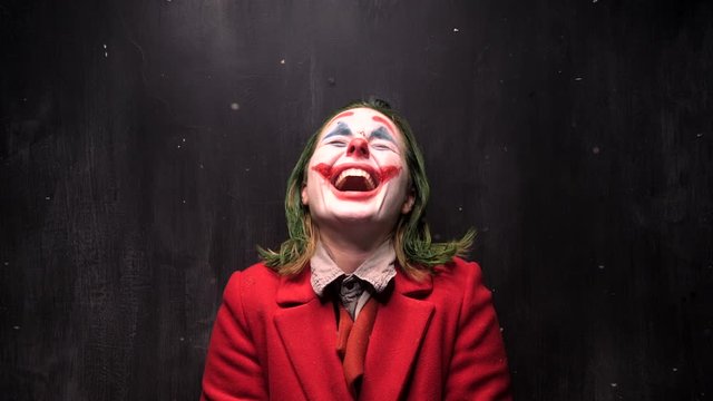 Woman in clown cosplay laughing, halloween concept