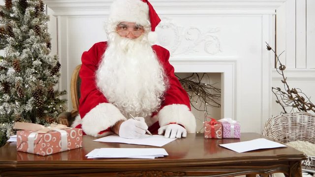 Santa Claus thinking what to write in his Christmas letter