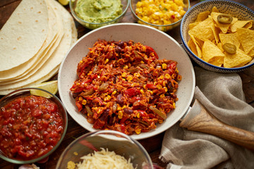 Mexican food concept. Vegetable burritos. Served on pan. Tortilla guacamole, salsa, chilli and beans