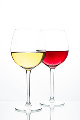 Two glasses with wine on a white background. Red wine. White wine. Apple juice. Cherry juice.