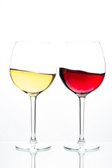 Two glasses with wine on a white background. Red wine. White wine. Apple juice. Cherry juice.