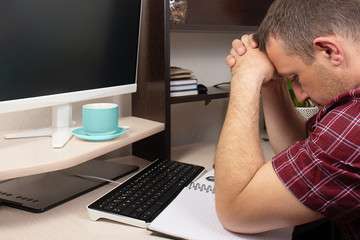 man at the computer, heavy stress over finances