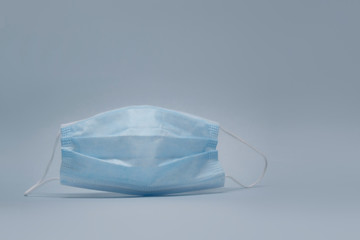 Medical mask from Covid-19 Coronavirus on a light background. Stock photo on the theme of the medicine.