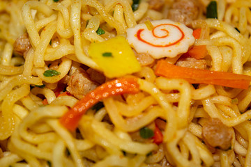 Cooked instant noodles with spices, dried vegetables and freeze-dried meat. Close up.