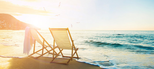 Background with couple of deck chairs at sunset, Travel concept, Summer background