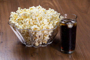 Popcorn and soda on the wooden table