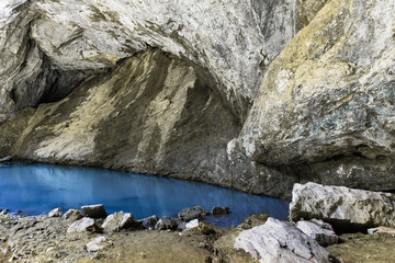 Concept archaeology, geology, research and excavation. Lake with clear and blue river in a cave.