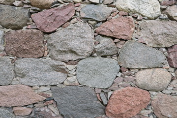 Old stone wall. Mosaic of large stones