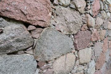 Old stone wall. Mosaic of large stones