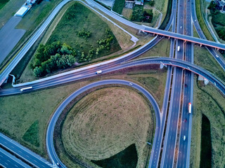 A beautiful panoramic aerial drone view of the sunset on the highway overpass of the southern...