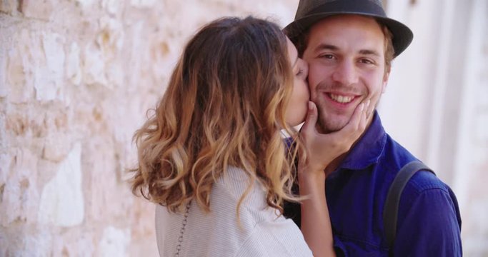 two people smiling portrait. Man and woman smiling and kissing portrait. Front view, close-up, slow motion.Man and woman looking at camera. Friendship or love concept.