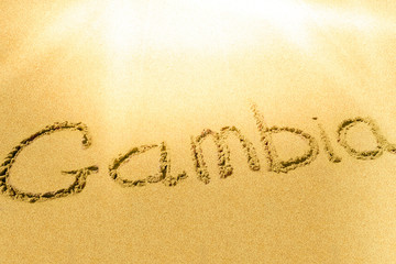 Gambia title on the sand beach Atlantic coast.