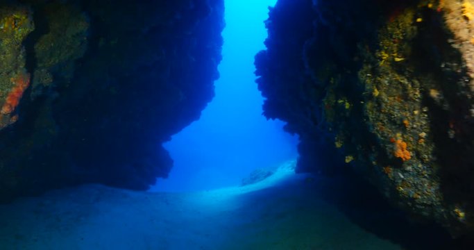 caves tunnels swimthroughs underwater for scuba divers to explore with nice lightning sun beams and rays ovean scenery