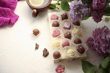 Fototapeta na wymiar On a white background is a board with handmade sweets. chocolates, 