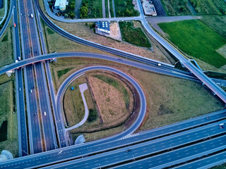 A beautiful panoramic aerial drone view of the sunset on the highway overpass of the southern...