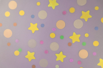Sparkle glitter confetti woth dots and stars on pastel lilac background. Shiny girly backdrop for your design. Festive greeting concept. Flat lay style. Top view