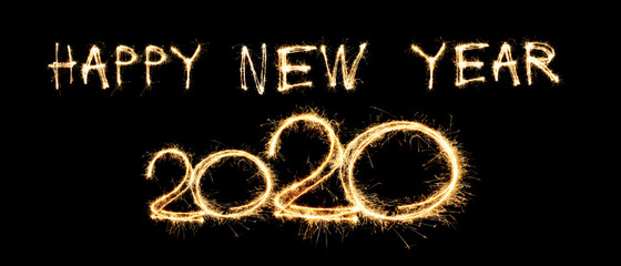 Happy New Year greeting text written sparkling sparklers isolated on black background and copy space.
