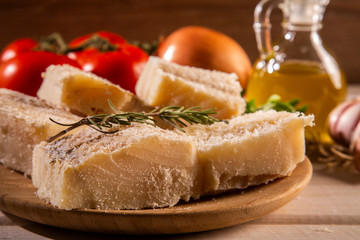 salted codfish on the wooden table with ingredients. Codfish raw.