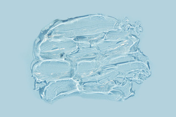 Fototapeta na wymiar swathes of trasparent gel on blue background