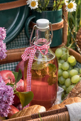 A bottle in a picnic basket outdoors