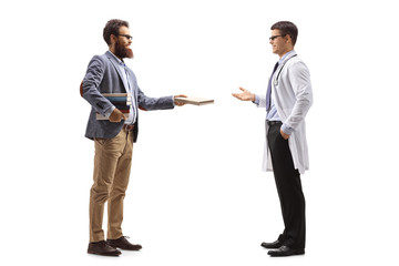 Fototapeta premium Bearded man giving a book to a male doctor