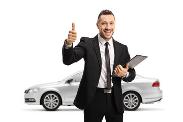 Man with a silver car holding a folder with a document and showing thumbs up